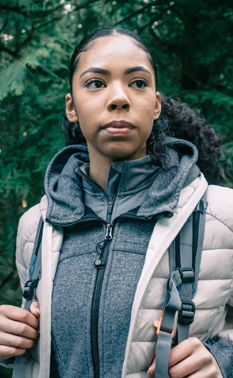 A young woman with a backpack looking ahead